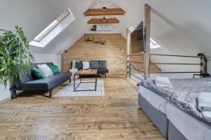 a bedroom with a loft with a bed and a couch at ZenLoft Apartman in Eger