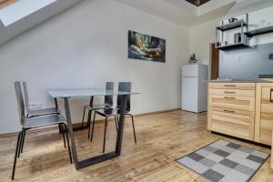 a kitchen with a table and chairs in a room at ZenLoft Apartman in Eger