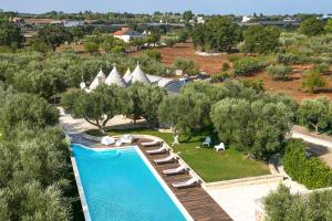 an aerial view of a resort with a swimming pool at Villa Trulli Carolina by Villa Plus in Noci