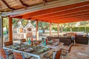 a table and chairs on a patio at Villa Trulli Carolina by Villa Plus in Noci