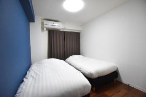 Postel nebo postele na pokoji v ubytování Randor Residence Tokyo Suites
