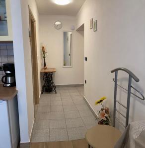 a hallway leading to a kitchen with a table at Funtana Apartments Budinjaš in Funtana