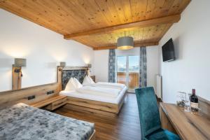 a bedroom with a bed and a table and a couch at Berggasthof Höllenstein in Wagrain