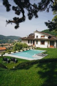 a swimming pool in the yard of a house at Villa ALMANA in Cernobbio