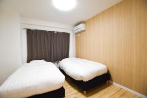 Postel nebo postele na pokoji v ubytování Randor Residence Tokyo Suites
