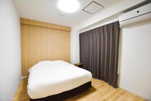 Postel nebo postele na pokoji v ubytování Randor Residence Tokyo Suites