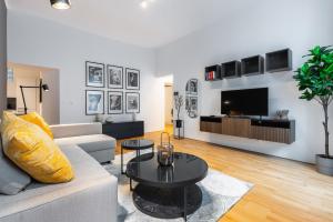 a living room with a couch and a table at Trendy apt with - smart TV, coffee machine in Meidling in Vienna