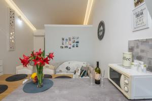 a living room with a table with a vase of flowers at Apartment Velika obala 2 in Bibinje +24 photos