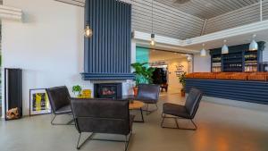 a lobby with a table and chairs and a fireplace at EuroParcs Marina Strandbad in Olburgen