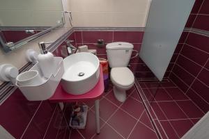 a bathroom with a white toilet and a sink at Grcka Reni Greece Beach Penthaus 3 in Nea Kalikratia +23 photos