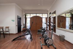 a gym with three exercise bikes in a room at KoolKost Syariah @ Cempaka Putih (Minimum Stay 6 Nights) in Jakarta