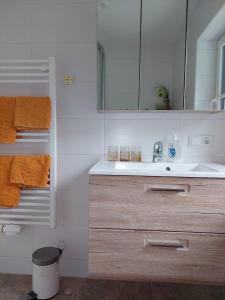a bathroom with a sink and a mirror at Appartements - Haus Sieberer in Brixen im Thale
