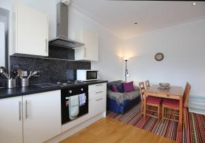 a kitchen and living room with a table and a couch at Law View in North Berwick