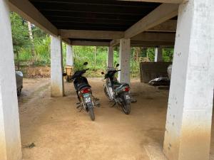 zwei Motorräder stehen in einer Garage. in der Unterkunft Teratak Sekayu ( Room Stay ) in Kuala Kerau