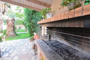 an outdoor grill in a brick building with a patio at Siamos Villa in Vonitsa