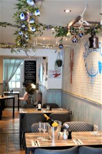 a restaurant with tables and chairs and a bar at Molesworth Arms in Wadebridge +115 photos