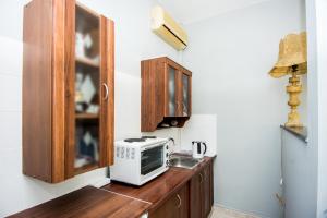 a kitchen with a sink and a microwave on a counter at Xenia Ionis luxury apartments in Lixouri