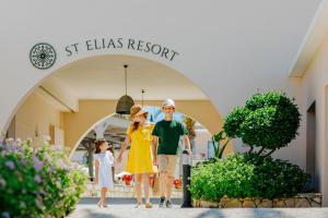 a family walking out of a st elias resort at Louis St. Elias Resort & Waterpark in Protaras