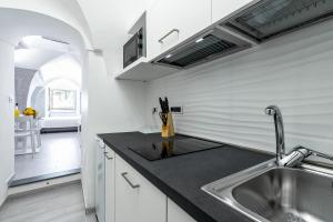 a kitchen with a sink and a counter top at Casapà in Atrani