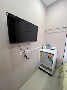 a room with a flat screen tv on a wall at Variety winner hostel in Hat Yai