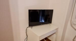 a television sitting on top of a white table at Danielle B&B in Rome