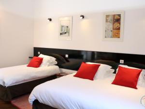 2 Betten in einem Hotelzimmer mit roten Kissen in der Unterkunft Gîte Romeries, 3 pièces, 5 personnes - FR-1-510-174 in Romeries