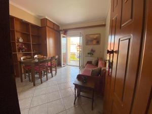 a living room with a table and a dining room at Mariangela Apartments in Lixouri +27 photos