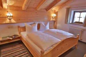 a bedroom with a bed in a wooden cabin at Berggasthaus Weingarten in Ruhpolding
