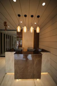 a lobby with a bar with lights on it at Hotel MariGold in Bhubaneshwar