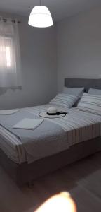 a white bed with a hat on top of it at Nikiana Family Apartment in Nikiana