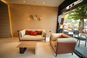 a living room with two couches and a coffee table at Hotel MariGold in Bhubaneshwar