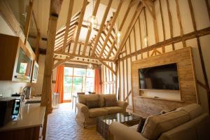 a living room with couches and a flat screen tv at Channels Hotel in Chelmsford