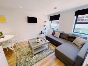 a living room with a couch and a table at Prosper House Apartment 4 in Norwich