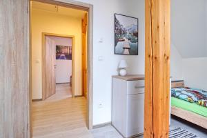 a bedroom with a bed and a hallway at Rezidence Podkova in Frymburk