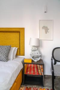a bedroom with a bed and a nightstand with a teddy bear sitting on at Mare Gaia Apartments in Skiathos