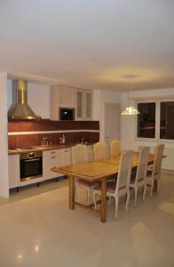 a kitchen with a wooden dining table and chairs at Gite HANSEL de la Ferme du Schneeberg in Wangenbourg