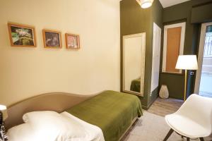 En eller flere senge i et værelse på Holiday Thea & Residence