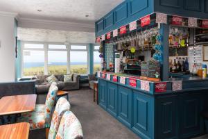 a bar in a restaurant with a view of the ocean at Kenton in Newquay