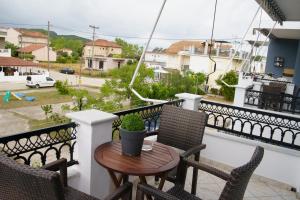 a balcony with a table and chairs and a view of a street at Mak Luxury Rooms in Parga