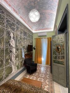 a room with a wall with a mural of a woman at I Bastioni Apartment in Palermo