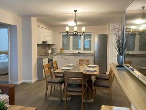 a kitchen and dining room with a table and chairs at Apartman Zaton in Zaton