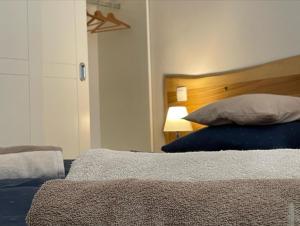 a bedroom with a bed with a wooden headboard at Apartman Zaton in Zaton
