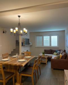 a dining room and living room with a table and chairs at Apartman Zaton in Zaton +53 photos