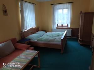 Posteľ alebo postele v izbe v ubytovaní Penzion selský dvůr