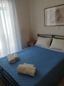 a bedroom with a bed with towels on it at Syros House with View in Ermoupoli