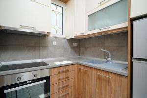 a kitchen with a sink and a stove at Studios Paradise in Limenas