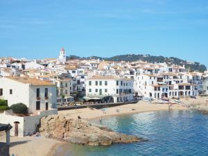 Blick auf eine Stadt mit Strand und Gebäuden in der Unterkunft Apartament gran amb vistes al mar, piscina i pàrquing in Calella de Palafrugell