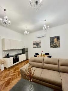 ein Wohnzimmer mit einem Sofa und einem Tisch in der Unterkunft Lux Apartmans in Pula