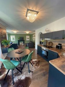 a kitchen and living room with a table and chairs at Blackforest Apartment in Freudenstadt