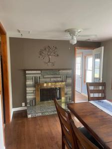 a dining room with a table and a fireplace at Three Bedroom House - Cape May short walk to the Bay in North Cape May